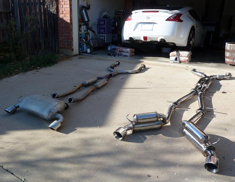 Replacing the stock exhaust with the Ark Grip V2 catback.  What a difference!  Both aurally and visually awesome!  (No, the car isn't rested on the bags of concrete.  They're just there to keep the car from pushing the rhino ramps back while I rolled up on them.  Parking brake on, front wheels chocked and turned off in first gear.)