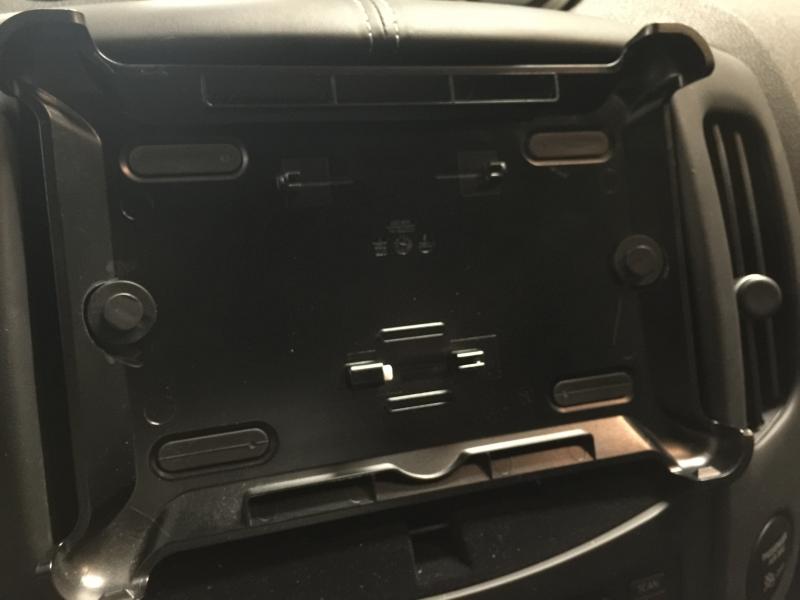 Otter box defender cover mounted over center dash cubby using two 1/4 fender liner pins.