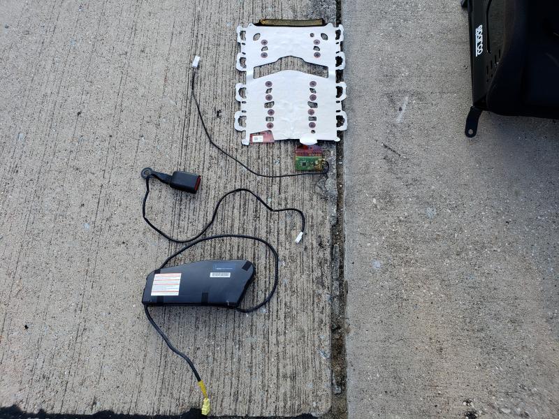 Seen here are the three pieces you will need to keep you car from getting mad at you.  The occupant pad and control  box is top. Seatbelt is center, airbag is bottom of the photo.