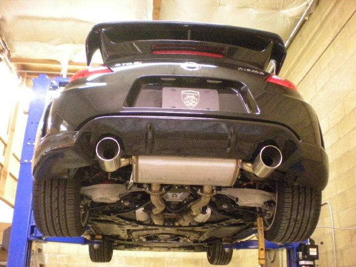 Car in the air showing the old OEM Nismo muffler section
