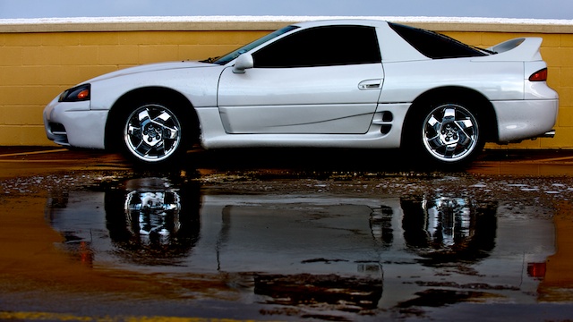 Parked next to a wall on the top level of a parking garage. melted snow is the foreground. I didnt even think about getting a reflection in the shot, but hey it turned out good as far as I'm concerned