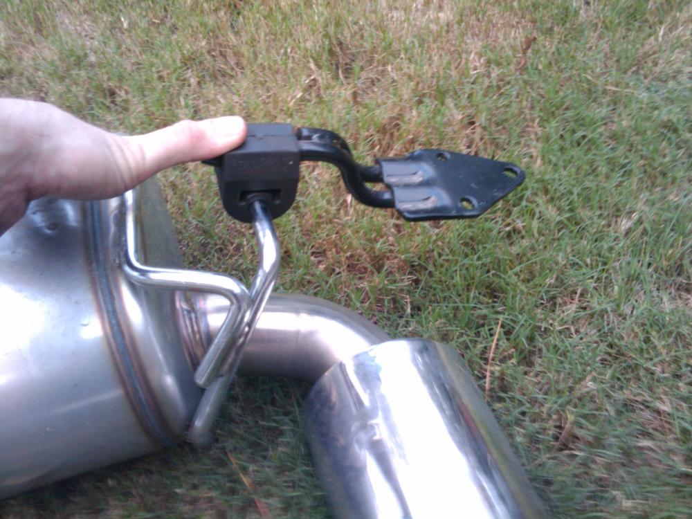 Unbolted Exhaust hanger. Instead of slipping the muffler off the hanger while under the car, I found it easier to unbolt the hangers completely. They come off with the use of a 14mm socket, it had (3) 14mm bolts.