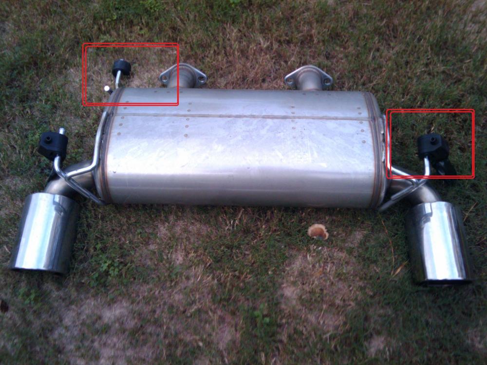 Do not re-install these two muffler hangers. The left one is not used, and the right one needs to stay off until you remove the charcoal filter cover - then you can put it back on.