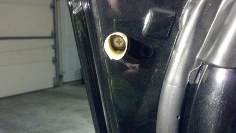 Masking tape rolled up sticky side out to make sure screw does not fall into door (2)