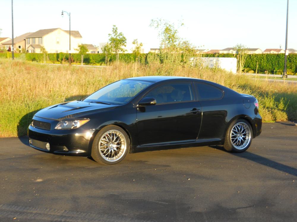 2006 Scion tC: Toyota 3.3l VVTi. TRD springs, struts, rear sway, shifter & knob, rad cap, muffler, TRD/Quaife LSD. Megan Racing mid pipe. Exedy stage one clutch. Fidanza Solara/ES300 flywheel. Stoptech rotors. Akebono pads. Energy Suspension hyper flex master kit & motor mounts. Hotchkis strut bar. Eibach rear upper control arms. Scion security, dash lights, fog lamps, doorsills, steering wheel,   rearview mirror, and mats. Seibon VSII CF hood. HP Evo 18x8. Pioneer AVH3400BT, Rockford Fosgate Prime Sub & Amp, Bazooka Sub Enclosure.