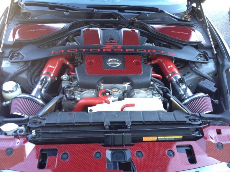 Jim Wolf Tech short ram intake.
Z1 Motorsports red silicone hosing and decal.
red and black submerged carbon fiber graphics