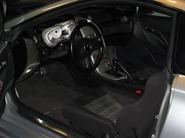 TRD Supra Steering Wheel Red Stitched, Custom CF Dash, Color Coded Vents, Center Console, Custom TRD Center Tach/Speed Gauge Blue L.E.D., Full Suede JDM Bride Interior, 2003 Black Panel Interior Swap, JDM Toyota Window Visors, JDM Celica Alluminum Door Sill Plates, CF Armrest,TRD Short Shifter