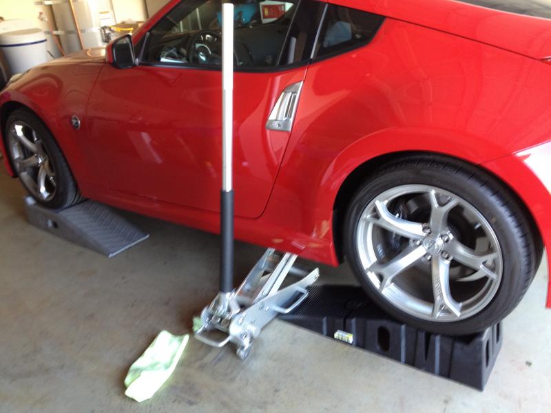 Raised on 2 set of rhino ramps and two floor jacks (backup)